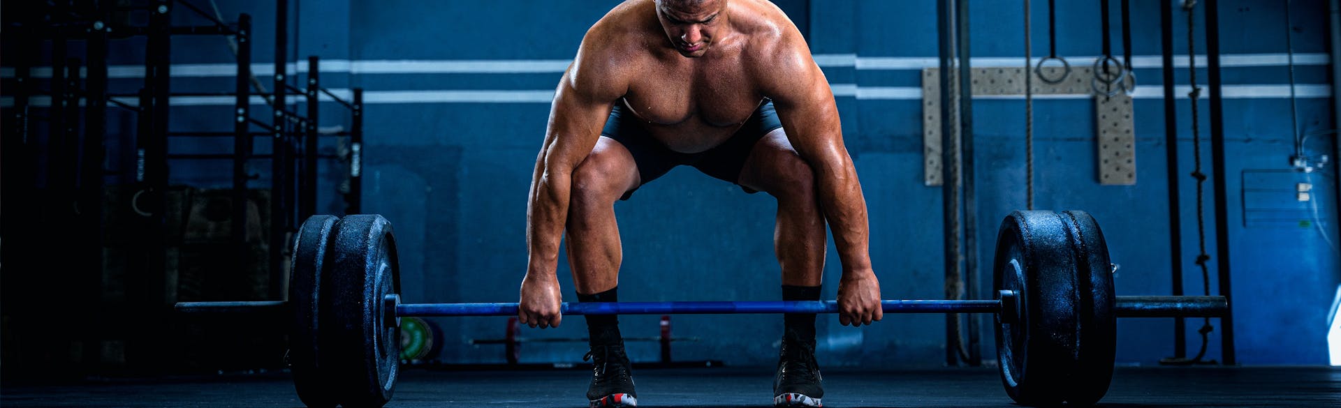 A weightlifter picking up some weights.