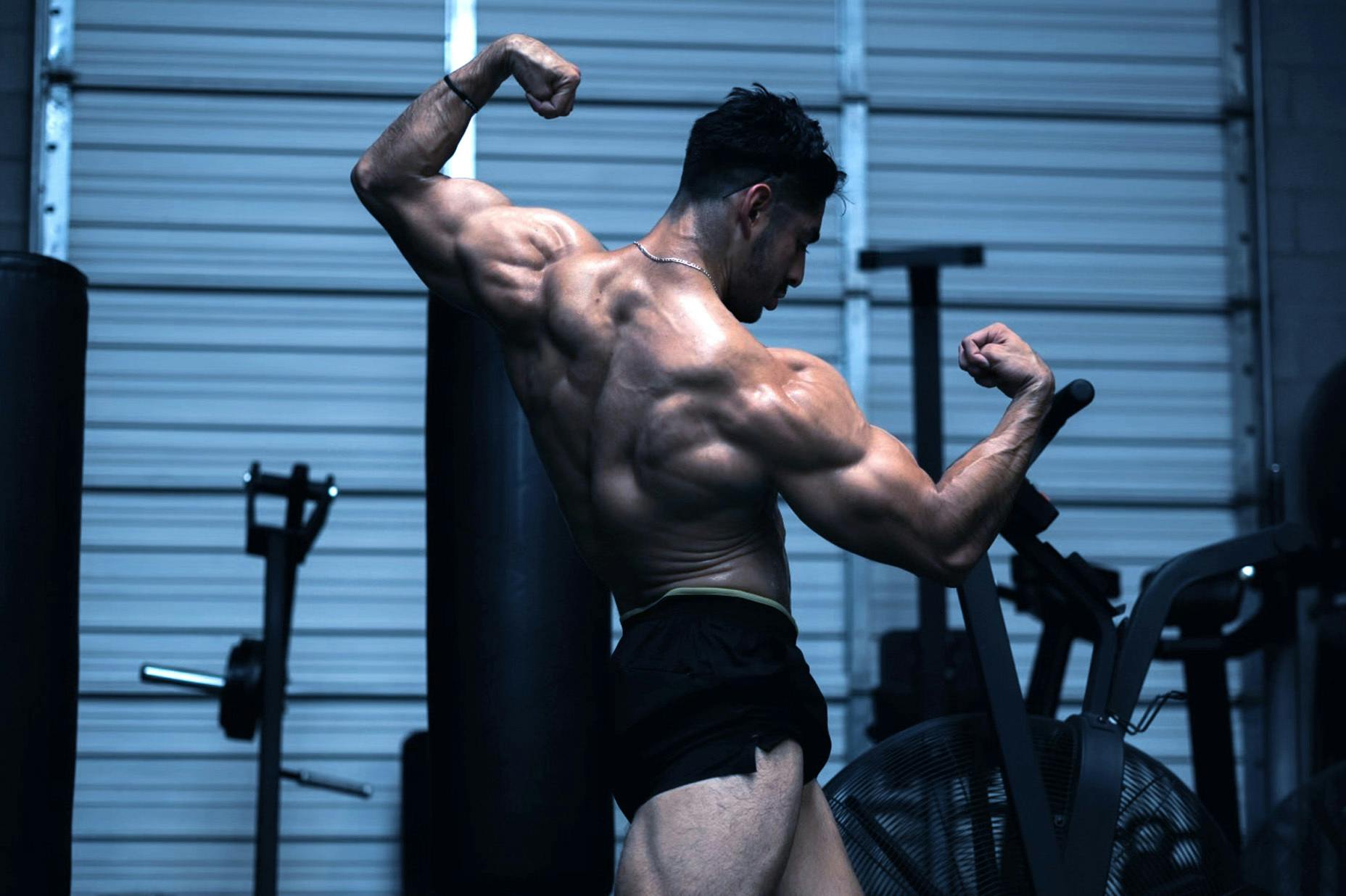 Christian Romo flexing in a gym.