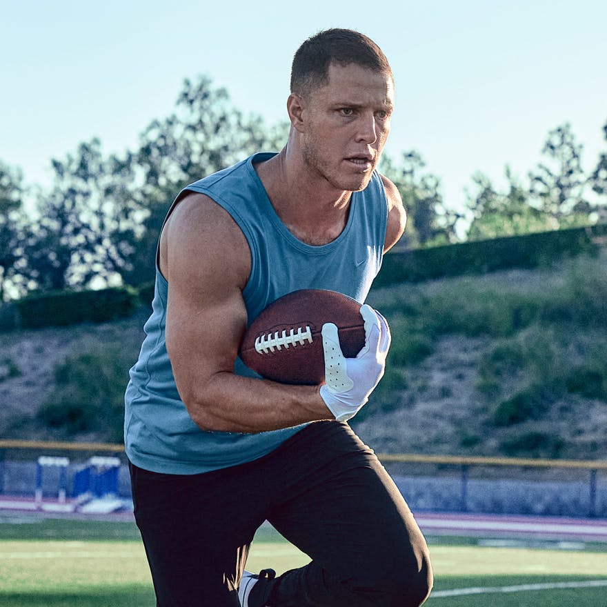 CMC at practice holding a football